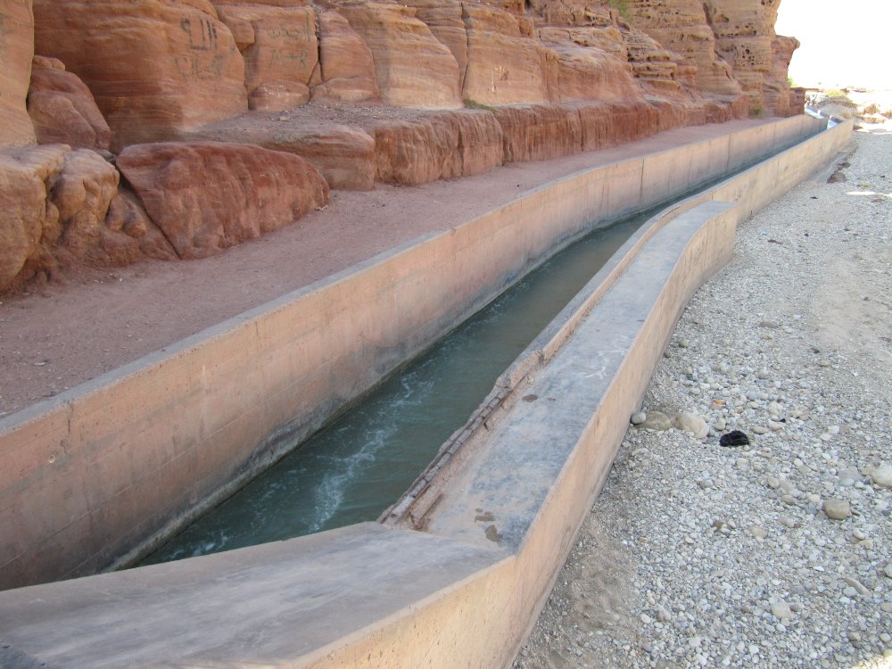  JVA open water channel running along the Wadi Hasa. Remnants of an older water channel carved into the rock are to the left. Older water channels are thought to date back to the mid twentieth century, the Mamluk and Roman periods.